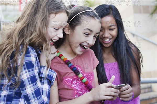 Friends looking at cell phone