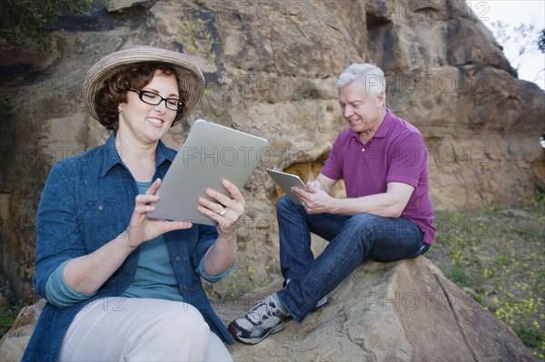 Caucasian couple using digital tablet in remote area