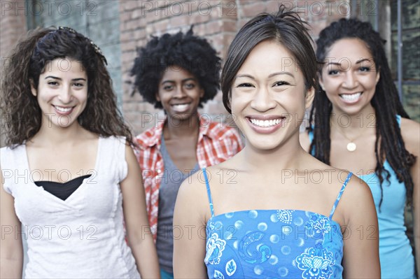 Smiling women standing together