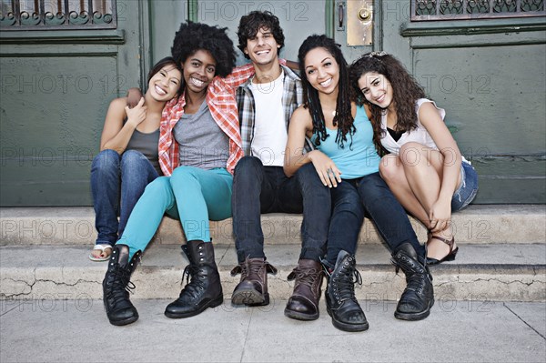 Friends hanging out on front stoop