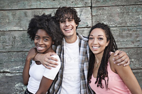 Smiling friends hugging