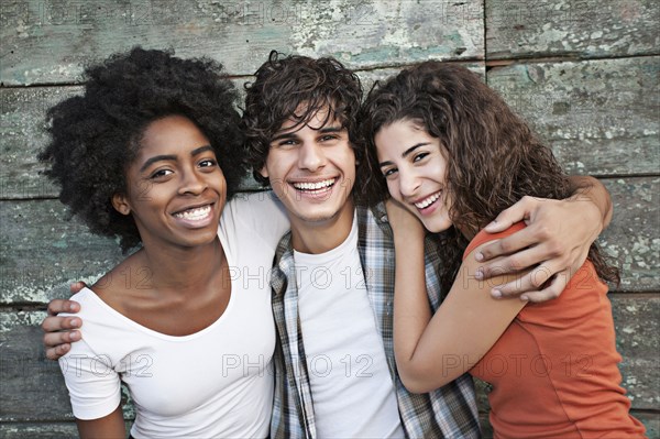 Smiling friends hugging