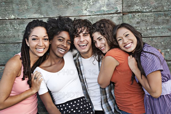 Smiling friends hugging