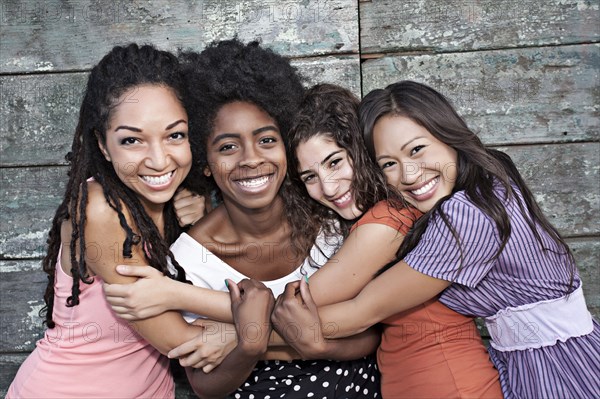 Smiling friends hugging