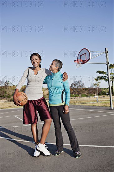 Mother and daughter playing basketball