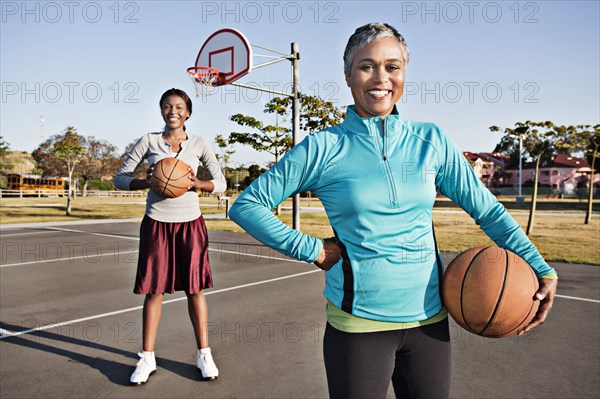 Mother and daughter playing basketball