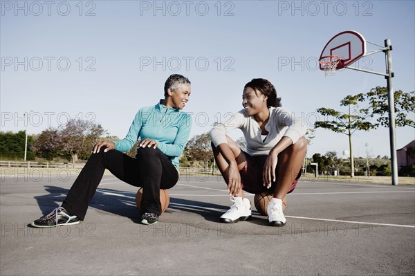 Mother and daughter playing basketball