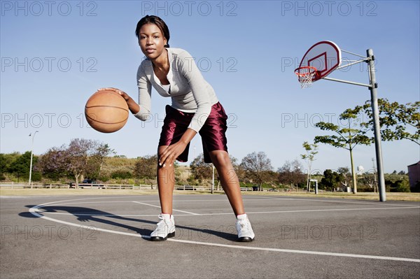 Young woman playing basketball