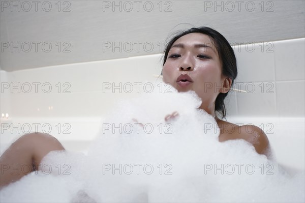 Woman enjoying bubble bath