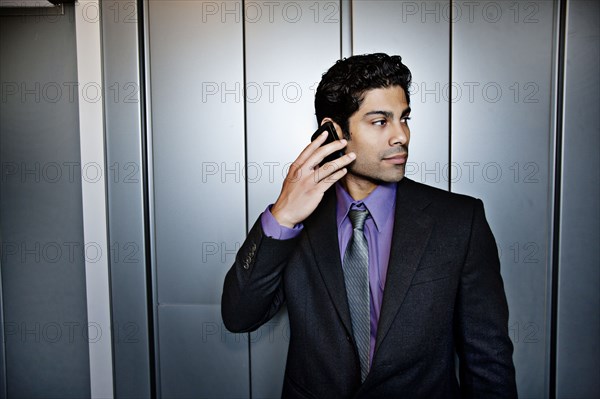 Hispanic businessman talking on cell phone