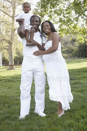 African American family standing together in park