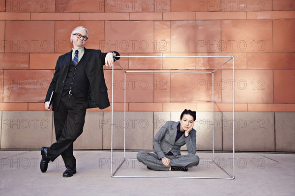 Businessman standing next to co-worker in box