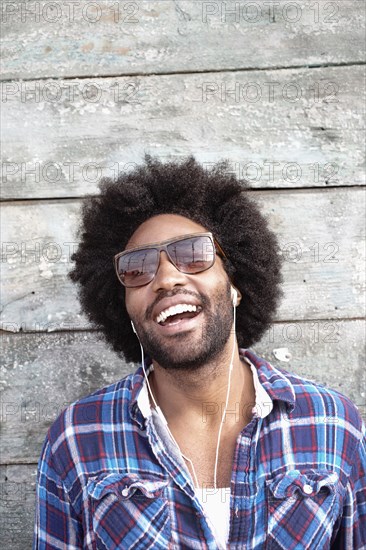 Smiling Black man listening to mp3 player