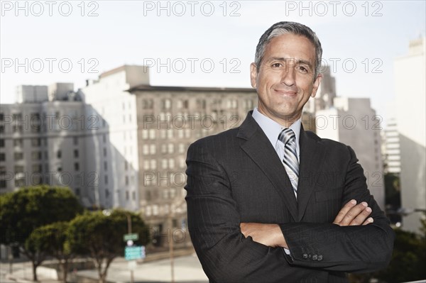 Hispanic businessman standing outdoors