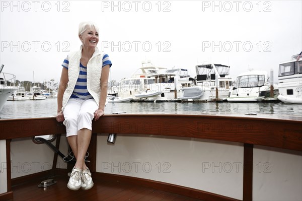 Smiling woman sitting on boat