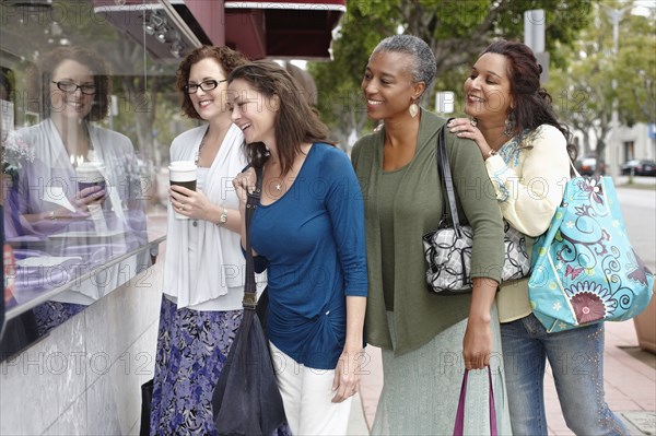 Friends shopping together in city