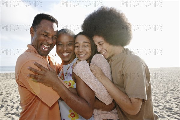 Family hugging on beach