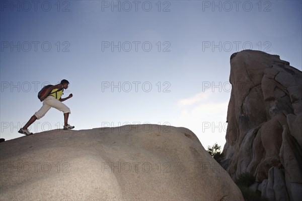 Woman hiking on large rock