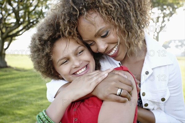 African American mother and daughter hugging