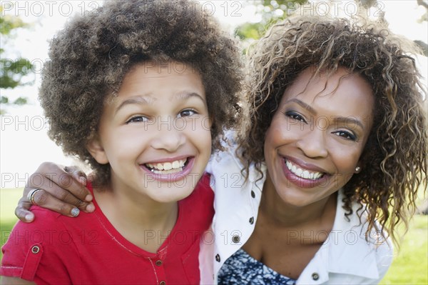 Smiling African American mother and daughter