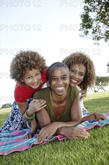 African American family laying in park