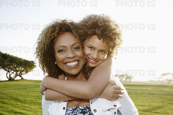 African American mother and daughter hugging