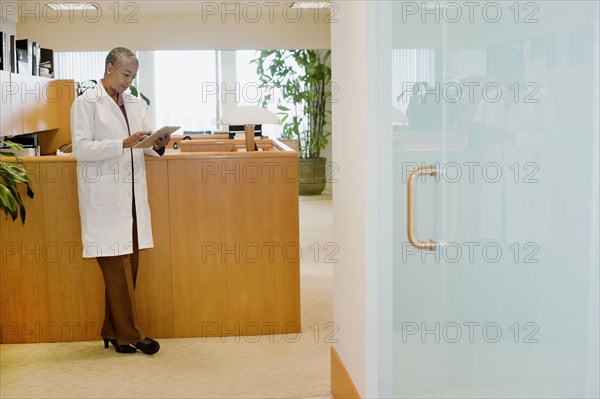 Black doctor using digital tablet