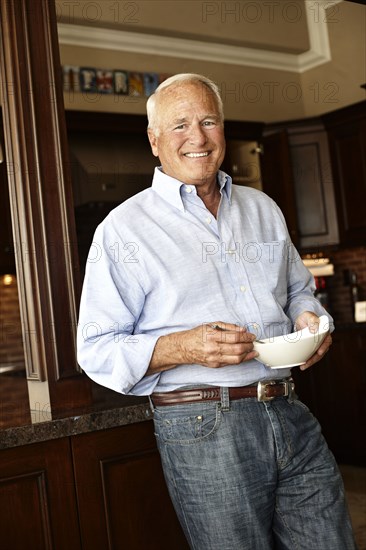 Caucasian man holding bowl