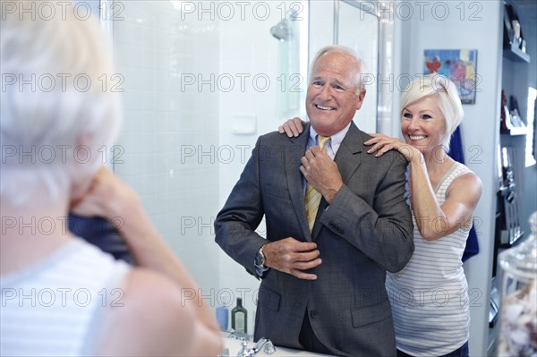 Caucasian couple dressing in bathroom