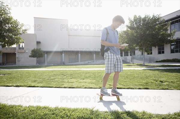 Mixed race boy on skateboard