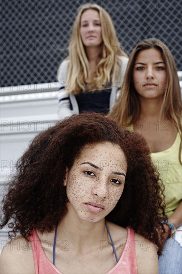 School friends sitting together on bleachers