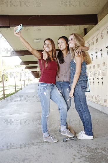 School friends taking self-portrait with cell phone