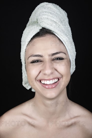 Mixed race teenager with head wrapped in a towel