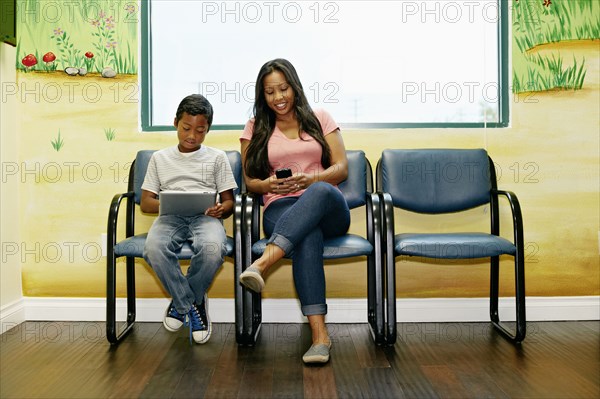 Mixed race boy and mother in waiting room