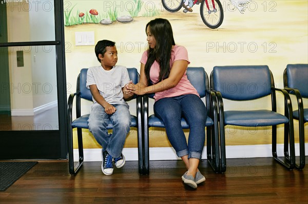 Mixed race boy and mother in waiting room