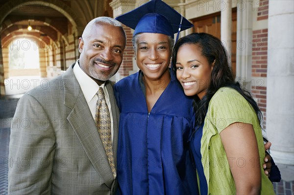 Proud family standing with graduate