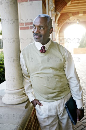 Black professor holding digital tablet