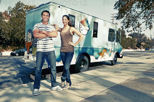 Couple standing by ice cream truck