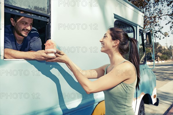 Woman buying ice cream from truck