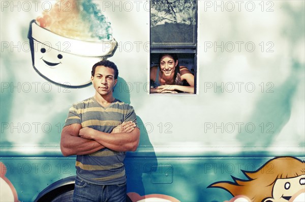 Couple posing by ice cream truck