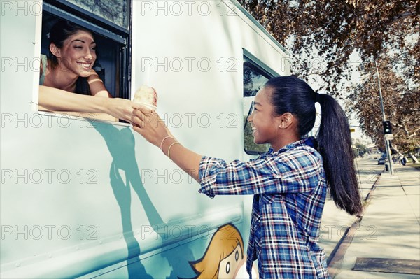 Girl buying ice cream from truck