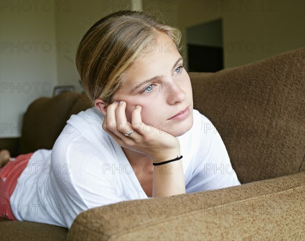 Caucasian girl laying on sofa