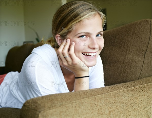 Caucasian girl laying on sofa