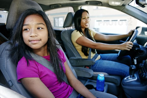 Mother and daughter driving in car