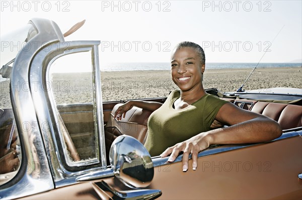 Black woman sitting in convertible