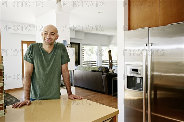 Hispanic man standing in kitchen