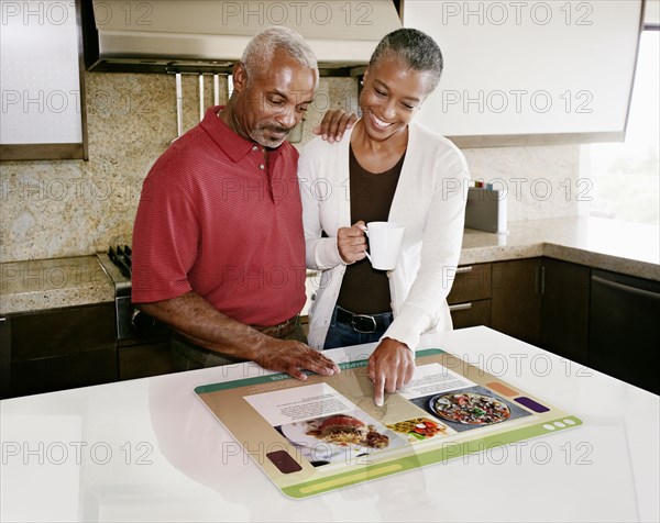 Couple using computer in table