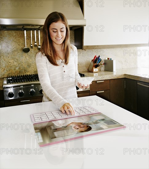 Caucasian girl using computer in table
