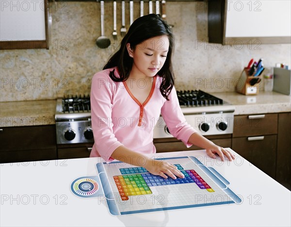 Asian girl using computer in table