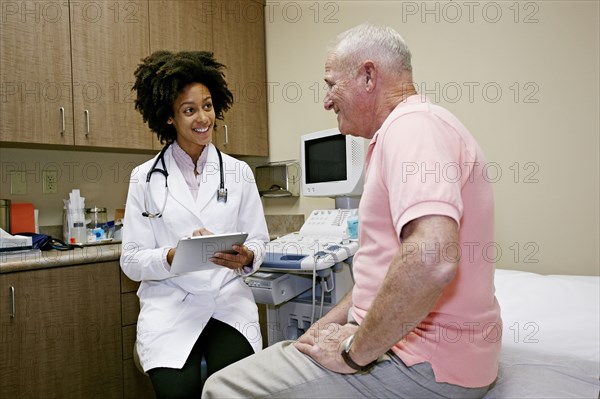 Doctor talking to patient in office